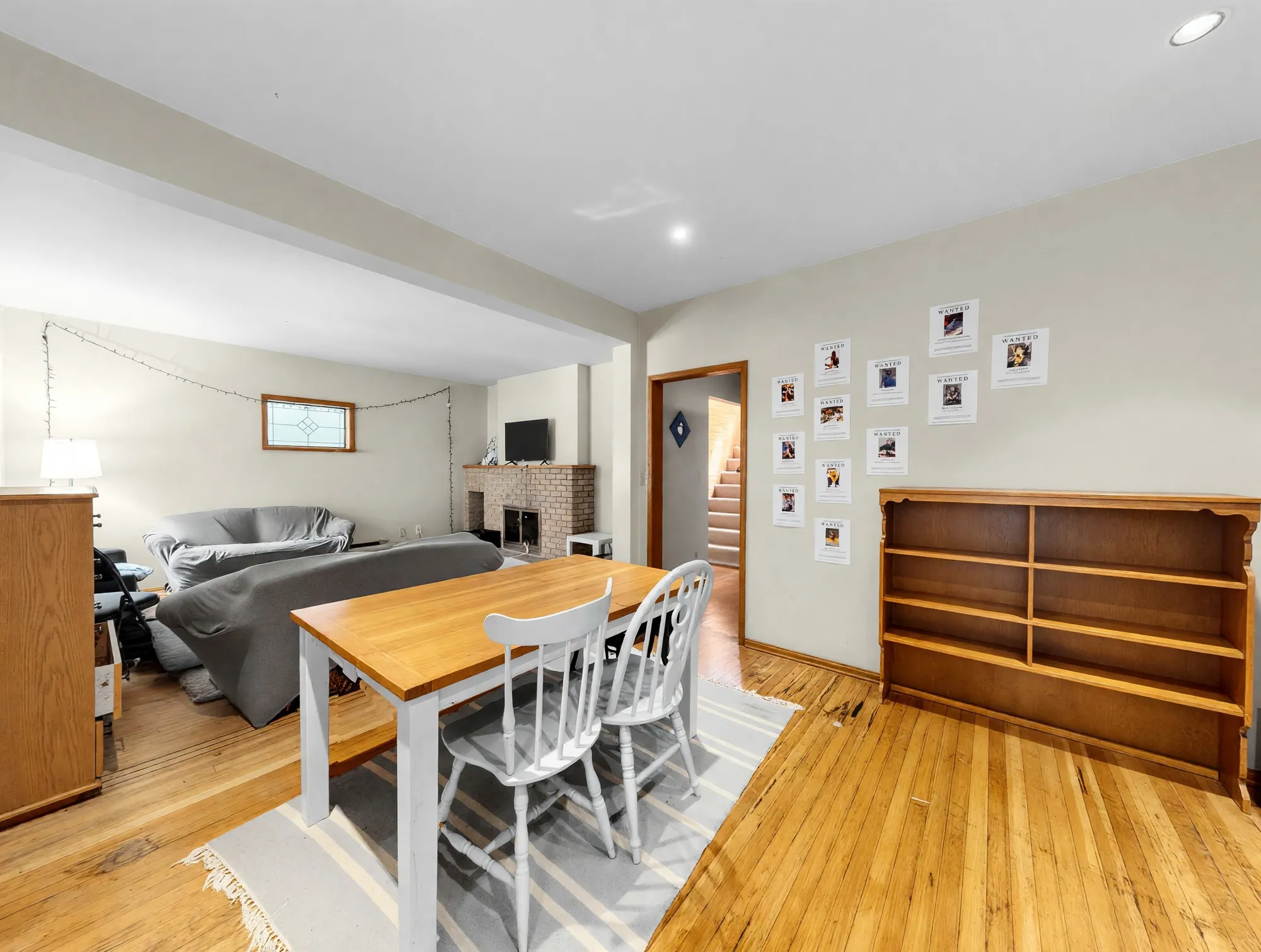 The dining room with hardwood floor and a stair beyond