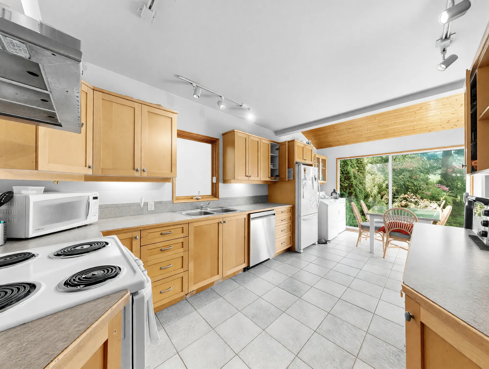 The main kitchen with maple cabinets and a tiled floor