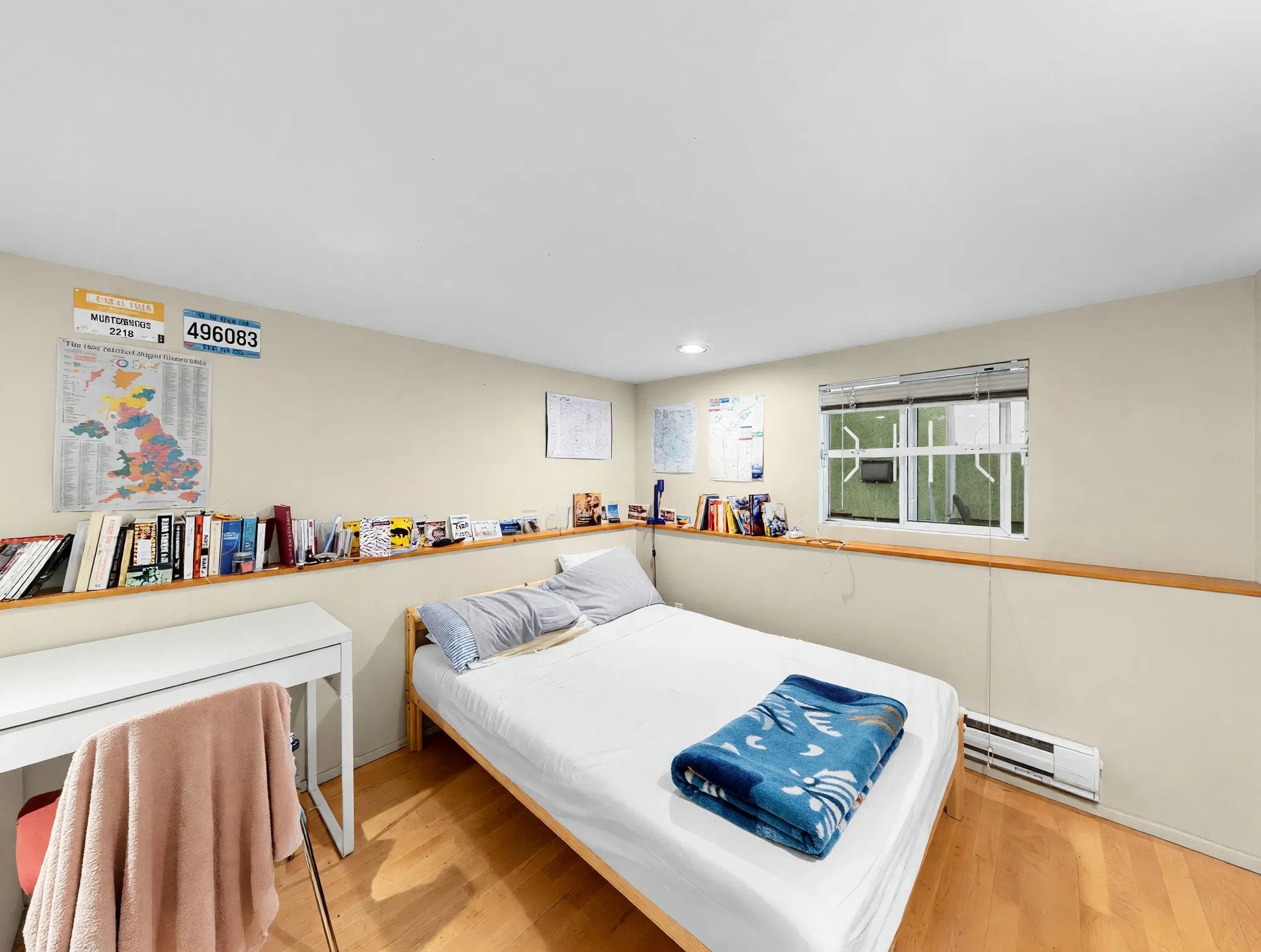 A room with a low ledge of books running the length of one wall